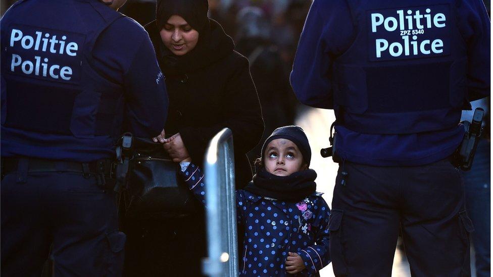 Woman and child enter the square ahead candle light vigil to the victims of the Paris attacks in Brussels' Molenbeek district (November 18, 2015)