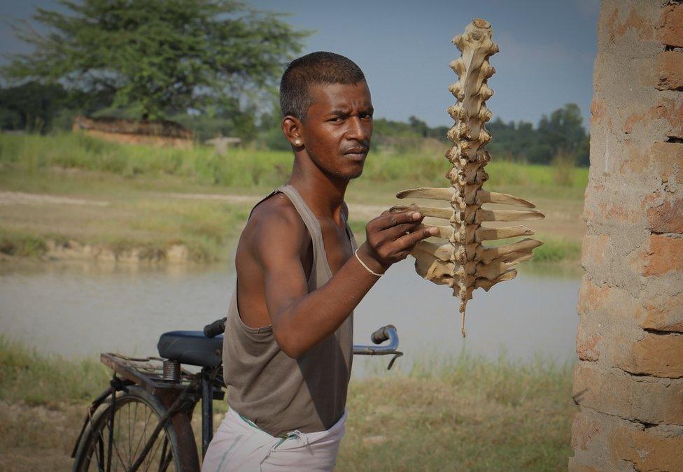 Sugreev shows an animal bone he has found