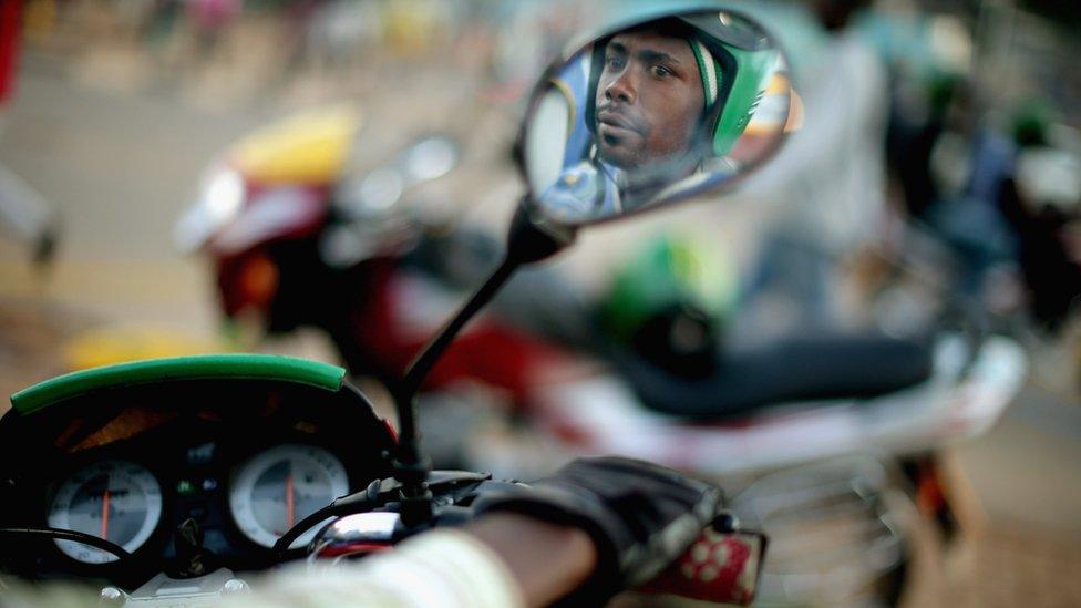 Motorcycle taxi driver Jean Claude Bigirimana, 31, waits for a customer at the Nyabugogo neighborhood bus park April 9, 2014 in Kigali, Rwanda.