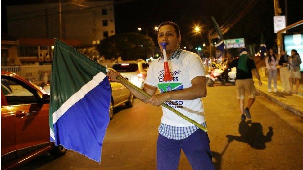 A supporter of Rodrigo Chaves celebrates in the street after Chaves won Costa Rica"s run-off presidential election against former President Jose Maria Figueres, in San Jose, Costa Rica, 3 April 2022