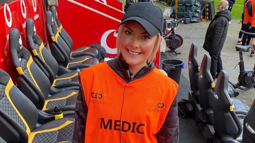 A woman in a high vis medic vest