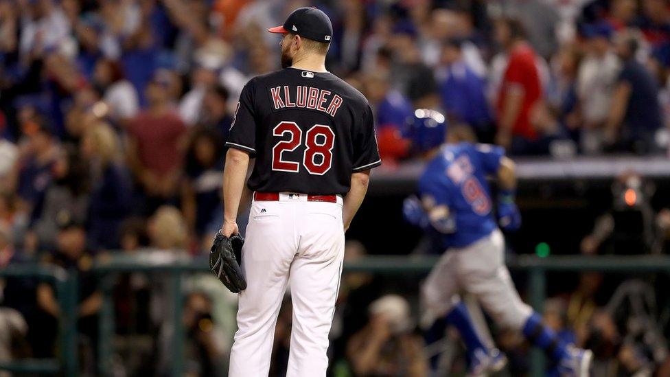 Cleveland Indians pitcher Corey Kluber watches as Javier Baez of the Chicago Cubs runs the bases after hitting a solo home run