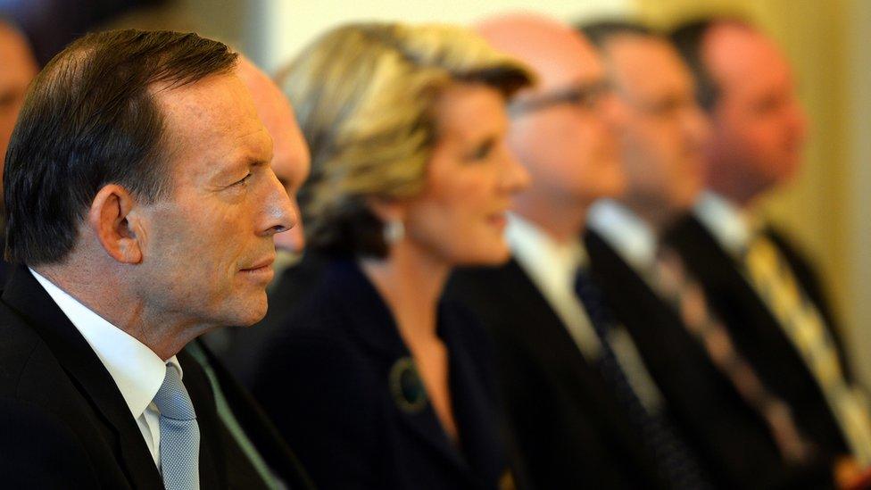 Tony Abbott (L) sits with his cabinet ministers during a swearing-in ceremony at Government House in Canberra in September 2013