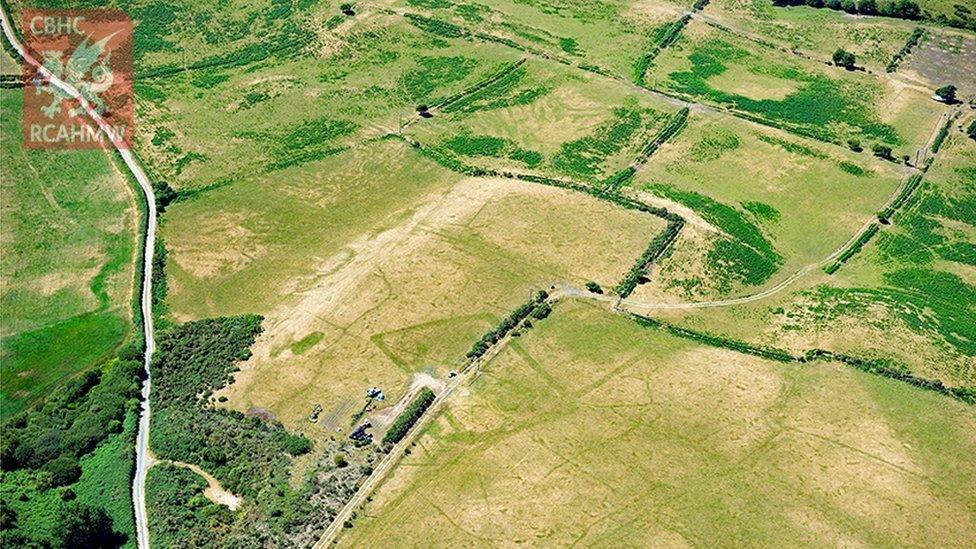 Prehistoric enclosures seen among the pastureland and fields