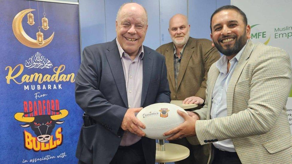 Rugby fan Graham Swain with Humayun Islam of the Muslim Friendly Employers project and (background) Nigel Wood, chairman of Bradford Bulls