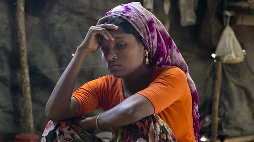 A Rohingya woman in the makeshift house she shares with 6 other refugees at a refugee camp in Cox's Bazar, Bangladesh.