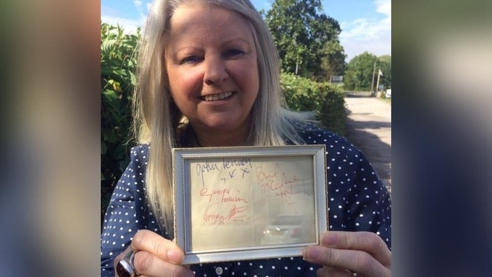 Hansons' music memorabilia specialist Claire Howell with the signatures