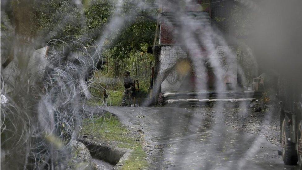 An Indian army soldier keeps vigil at his post by a military base at Braripora, near the de facto border dividing Kashmir between India and Pakistan, in Indian controlled Kashmir