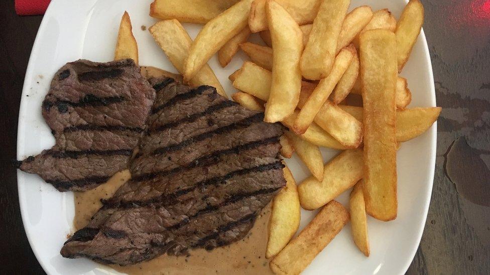 Close-Up Of Steak With Potatoes Served With Sauce