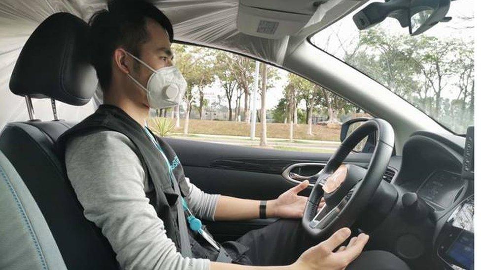 A safety driver wears face mask inside WeRide’s robotaxi during operation amid Covid-19 outbreak.