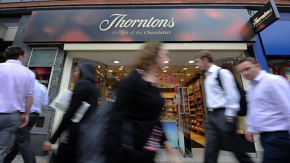 People walk past Thorntons shop