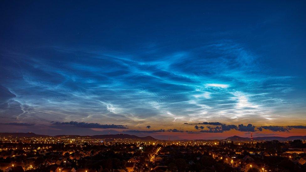 Wispy clouds in an early evening sky