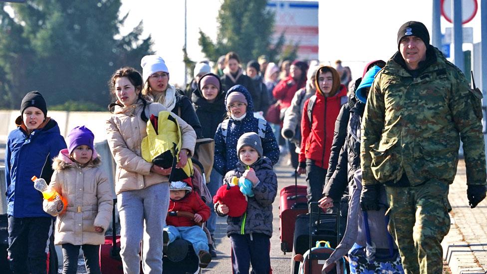 Ukrainian women and children cross the border from Ukraine to Poland at the Korczowa-Krakovets border crossing on 26 February 2022