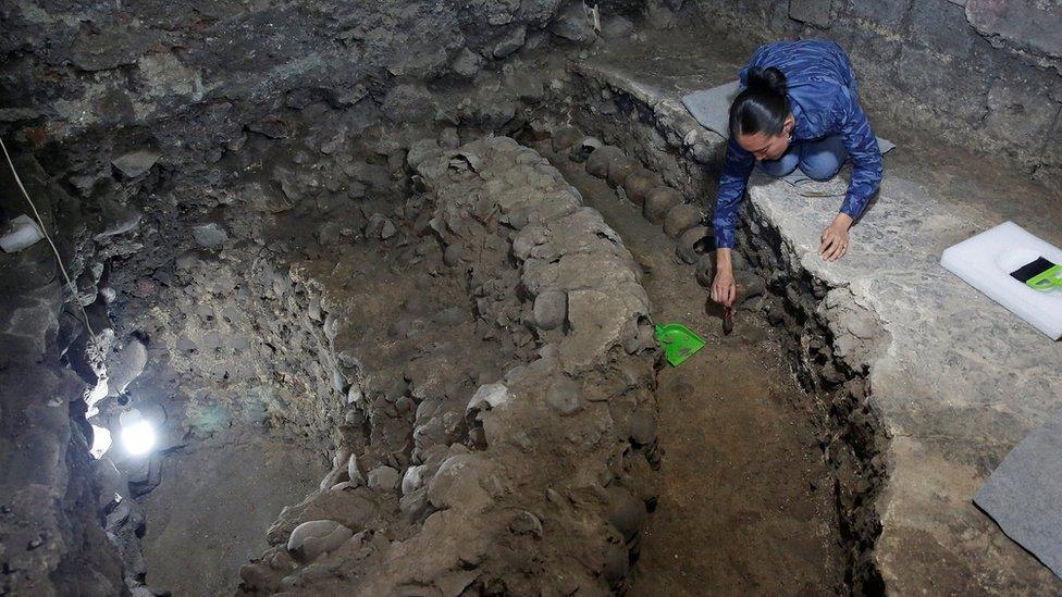 Lorena Vazquez, an archaeologist from the National Institute of Anthropology and History (INAH), works at a site where more than 650 skulls caked in lime and thousands of fragments were found in the cylindrical edifice near Templo Mayor, one of the main temples in the Aztec capital Tenochtitlan, which later became Mexico City, Mexico June 30, 2017