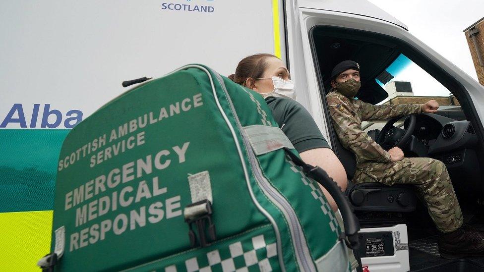 Paramedic with soldier at ambulance