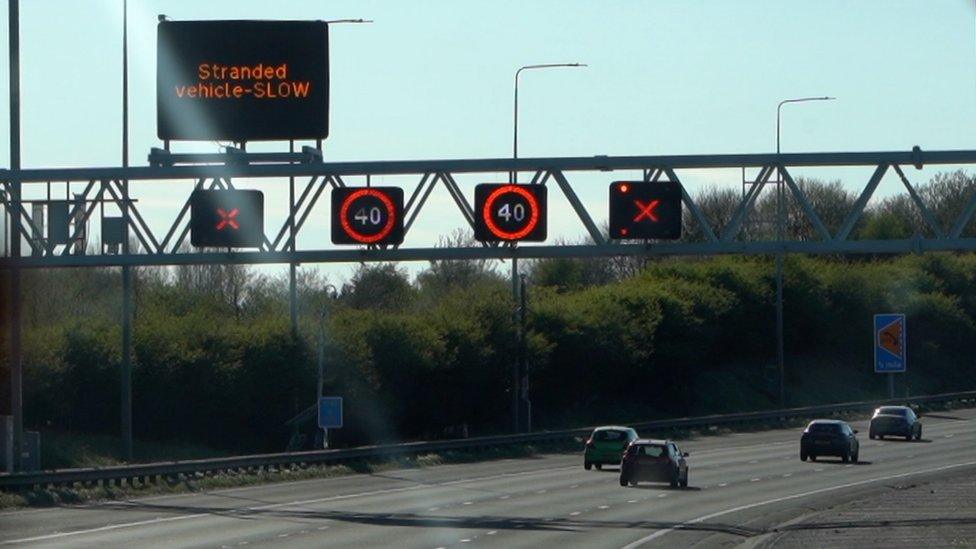 A road with red Xs on the overhead gantries