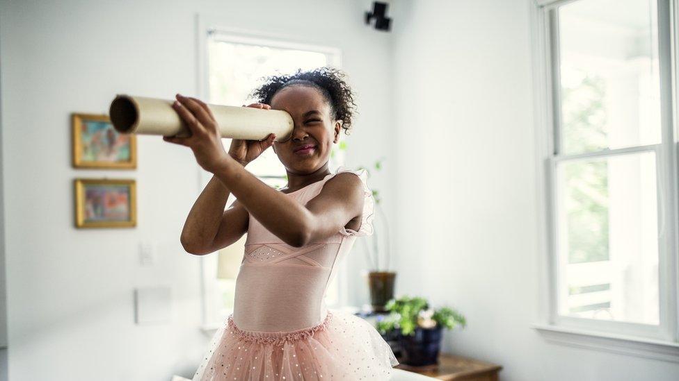 girl-in-ballet-outfit-looking-in-homemade-telescope