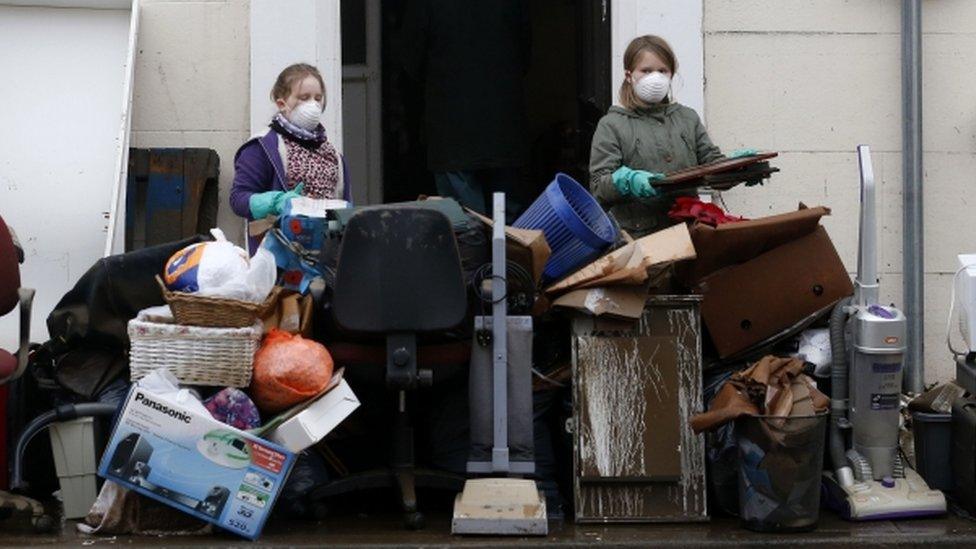 Residents and shop owners clear all their belongings onto the streets of Tadcaster