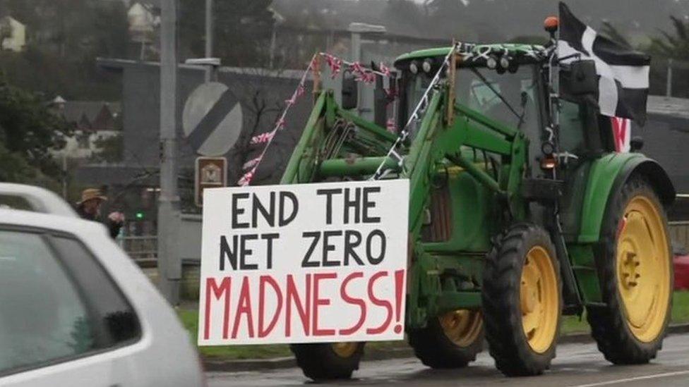 Tractor with sign on front saying 'End the net zero madness'