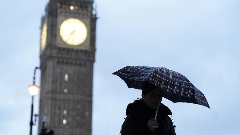 Woman with umbrella near Elizabeth Tower