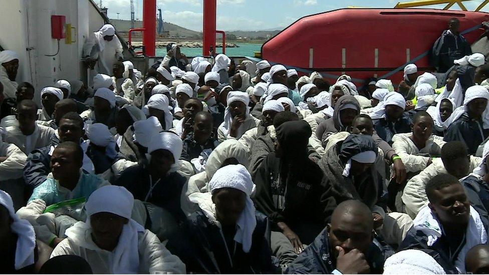 migrants on the deck of rescue ship