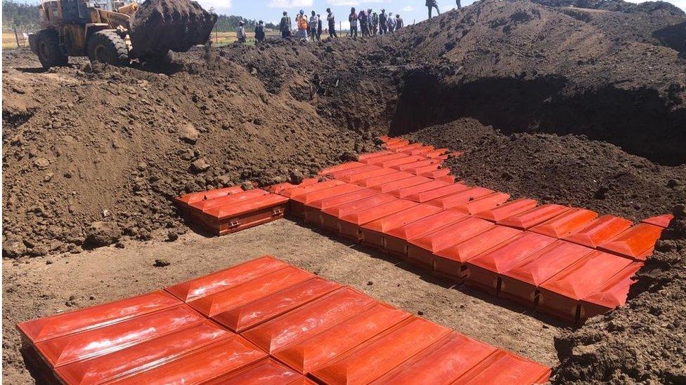 red coffins covered in dirt