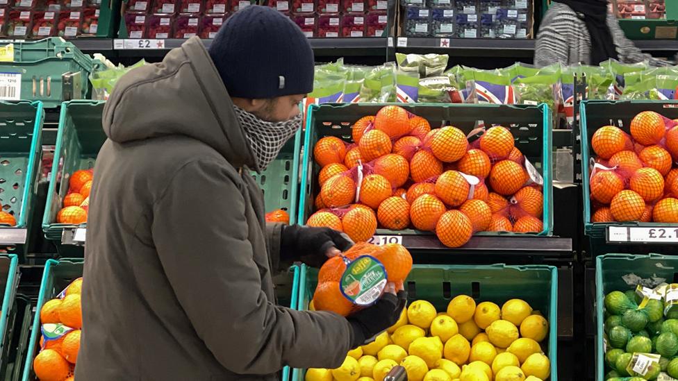 A customer shops for food items inside a Tesco supermarket store in London