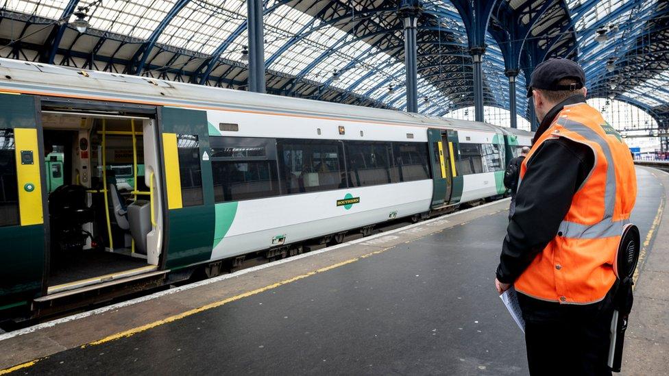 Train at platform with guard looking on