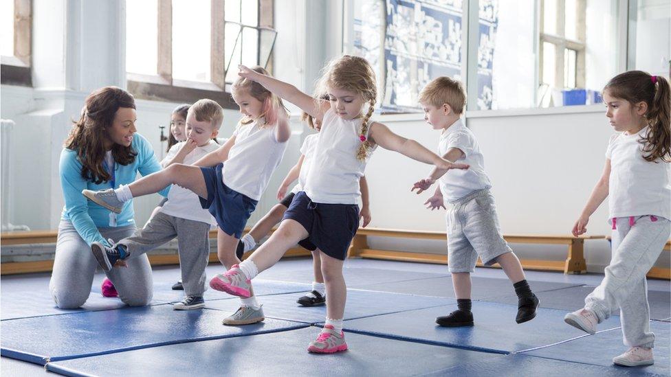 Teacher and pupils during a PE lesson