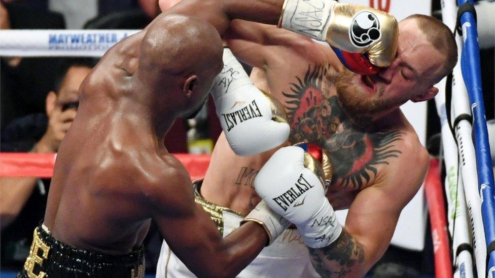 Flloyd Mayweather is pictured punching Conor Macgregor