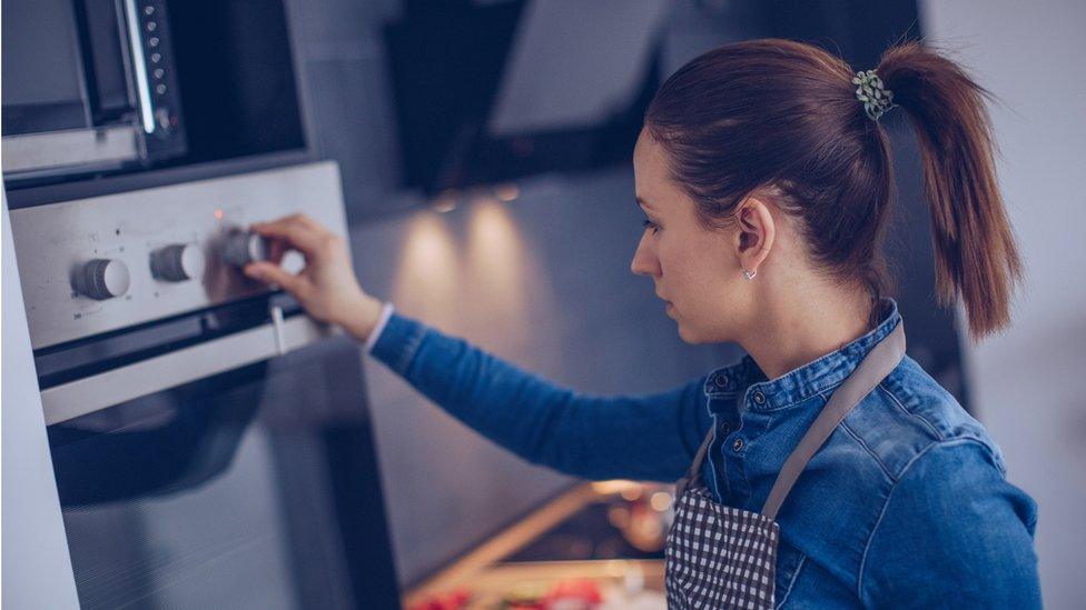 Woman using a cooker