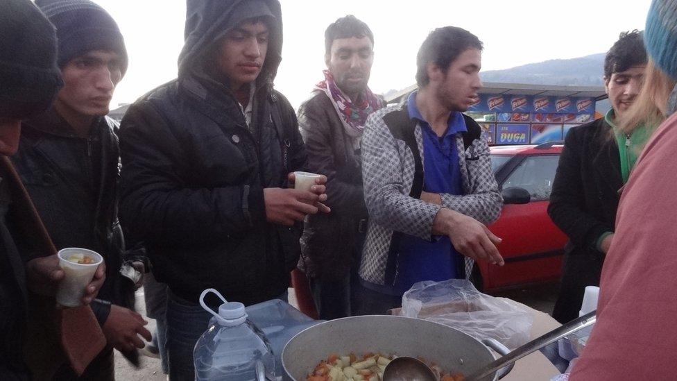 Migrants receiving soup