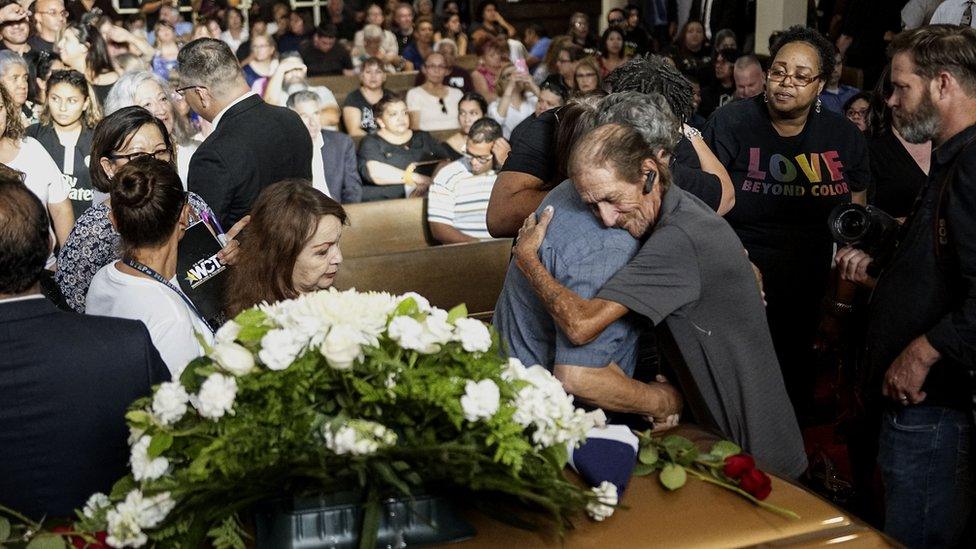 Antonio Basco in front of his wife's casket