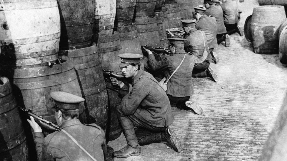 British Regulars sniping from behind a barricade of empty beer casks near the quays in Dublin during the 1916 Easter Rising