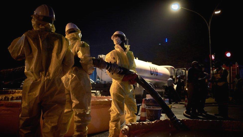 UN workers wearing suits and a masks for a sanitizing operation of the central market in Bamako on April 04, 2020.