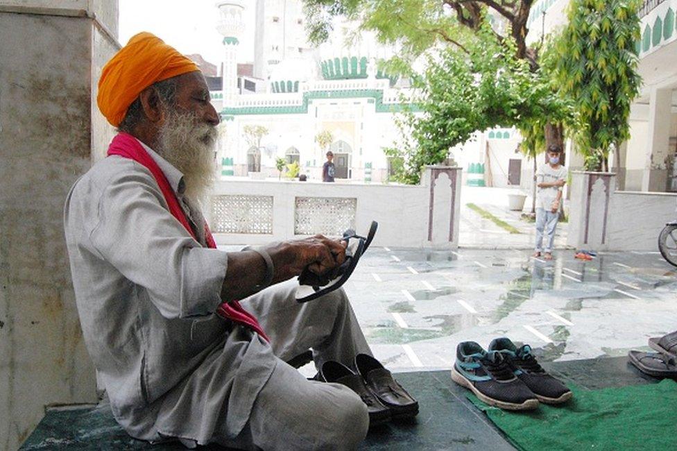 Baljinder Singh, 60, cleans shoes of devotees visiting the Khairuddin Mosque as a voluntary service, at Hall Bazaar, on July 17, 2020 in Amritsar, India.