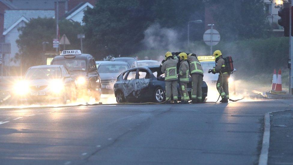 Fire fighters tackle a car on fire in Dundonald