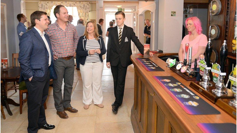 MP Robert Jenrick in a pub with others