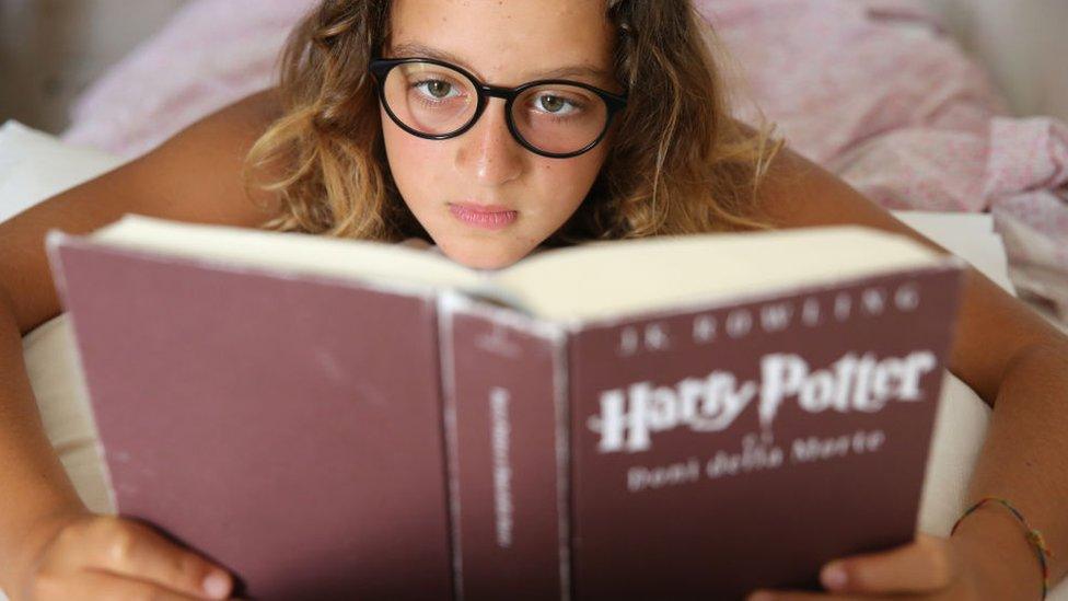 A girl reading the Harry Potter book