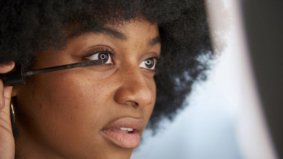 woman applying mascara