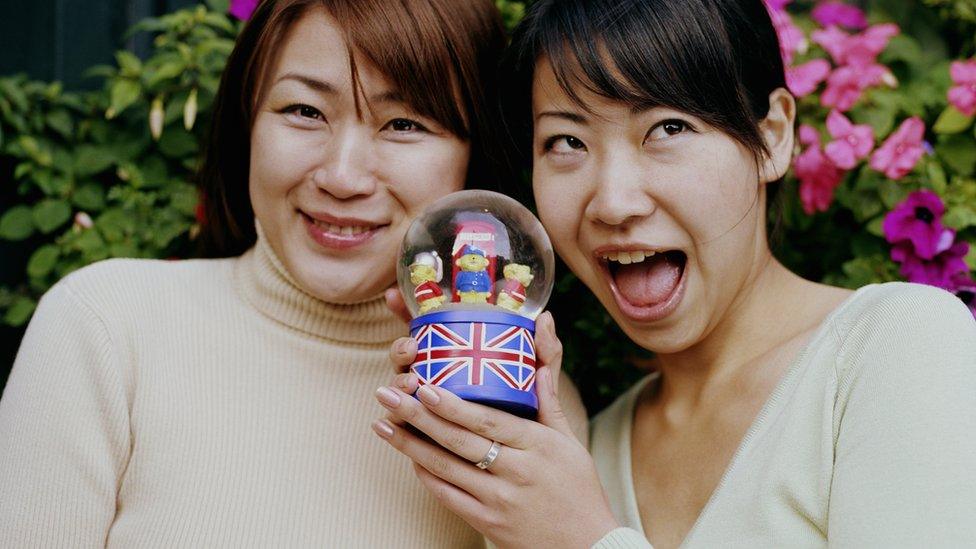 Two women holding a snow globe