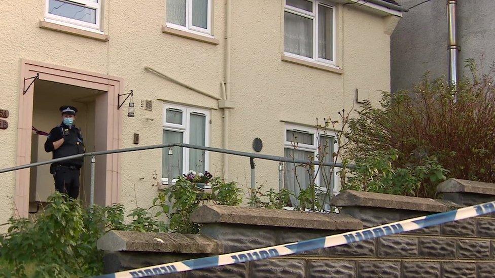 Police officer standing outside property on Market Street, Pembroke Dock