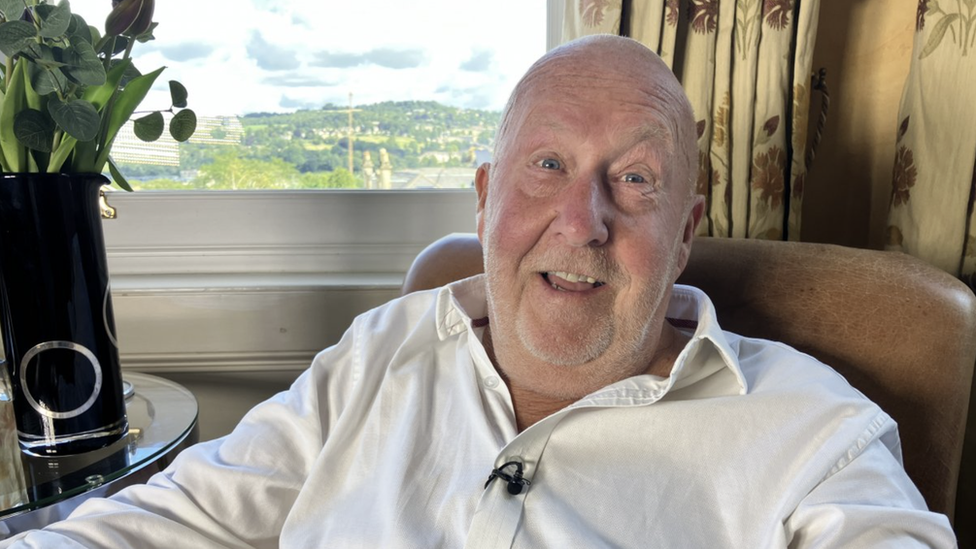 Dave Rolfe in a chair by a window