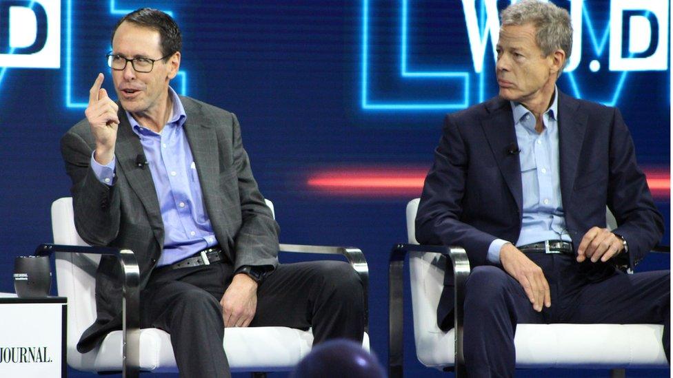 AT&T chief executive Randall Stephenson (L) and Time Warner chief executive Jeffrey Bewkes (R) defend the proposed mega-merger of the companies at a WSJD Live technology conference in Laguna Beach, California, on October 25, 2016.