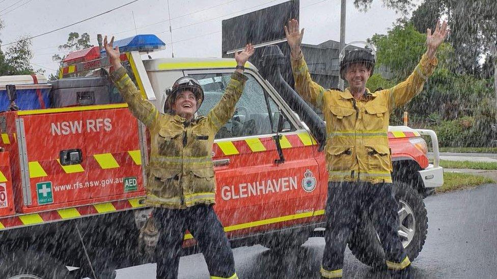 Fire crew in Australia celebrate the arrival of rain