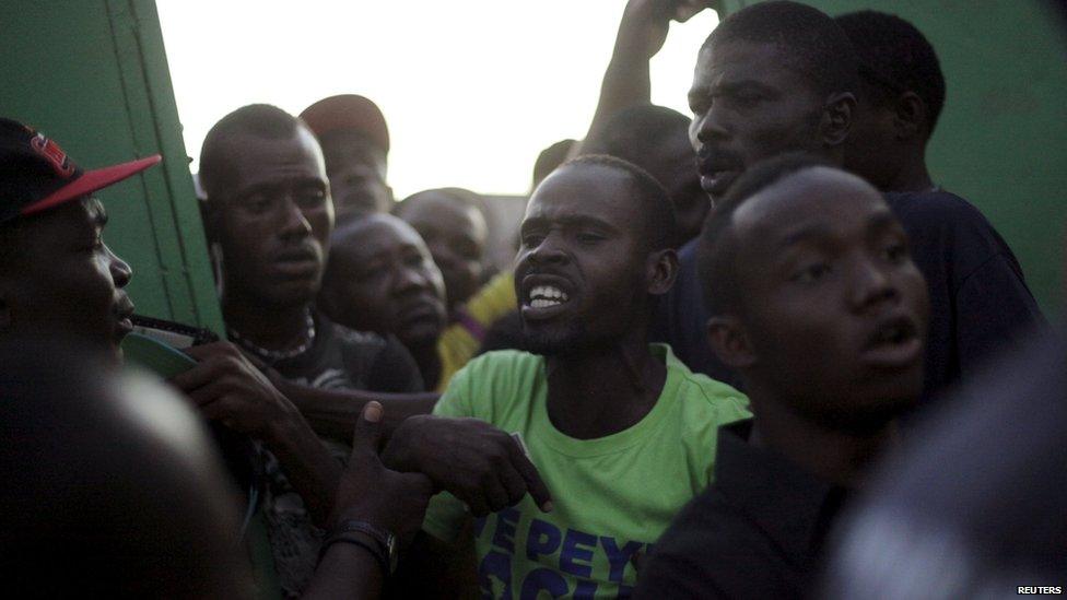 People argue at a voting station in Haiti