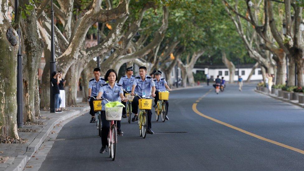 Security personnel ride bicycles on an empty road near the West Lake, as police closed off many roads before G20 Summit in Hangzhou, Zhejiang Province, China 31 August 2016.