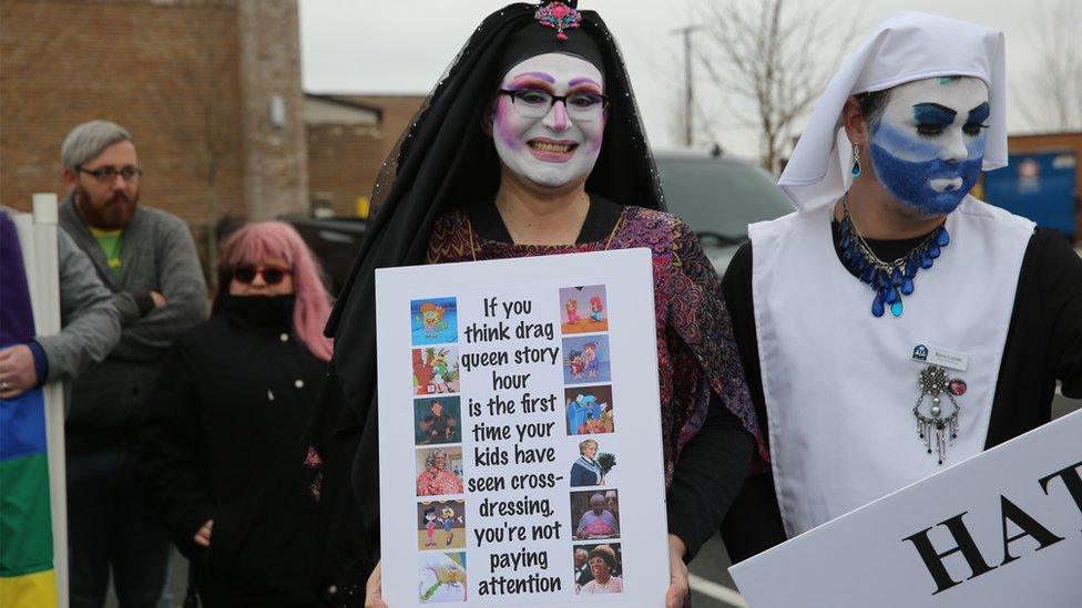 Counter-protesters holding a sign outside the Greenville public library