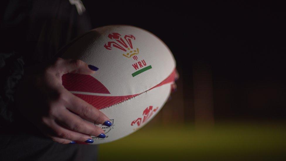 A player holding a rugby ball