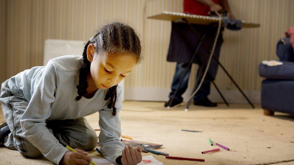 Girl colouring in on the floor